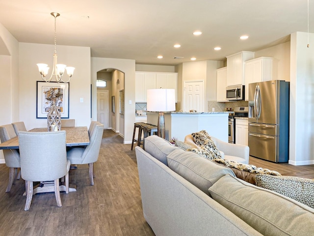 living room with dark hardwood / wood-style floors and a chandelier