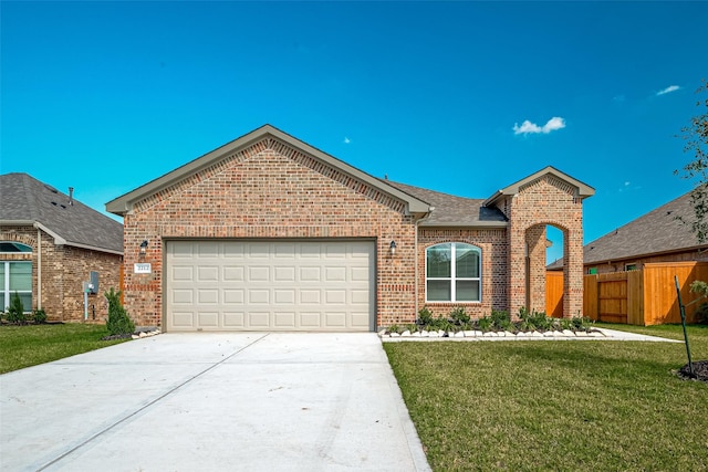 view of front of house with a garage and a front lawn