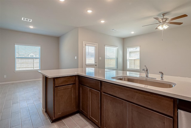 kitchen with ceiling fan, plenty of natural light, and sink