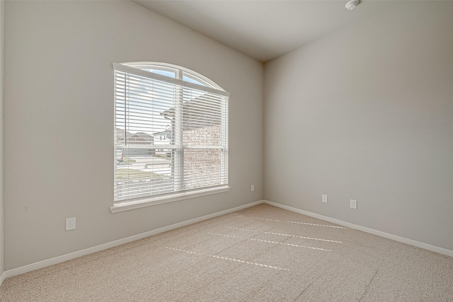 spare room featuring light colored carpet