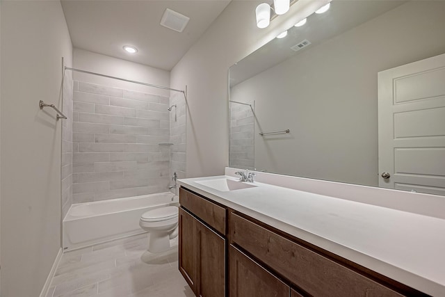 full bathroom with vanity, tiled shower / bath combo, and toilet