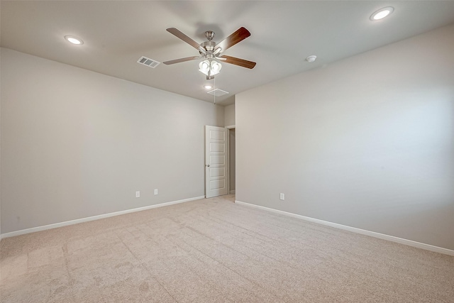 spare room featuring ceiling fan and light colored carpet