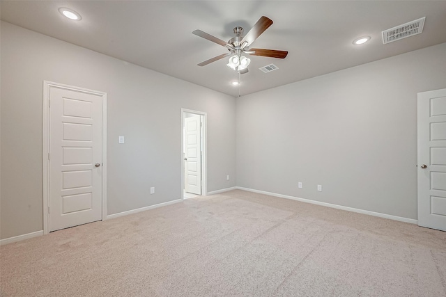 carpeted spare room with ceiling fan