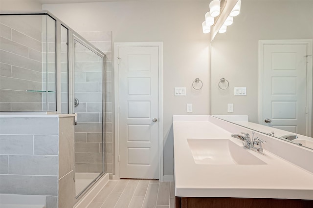 bathroom featuring vanity and a shower with door