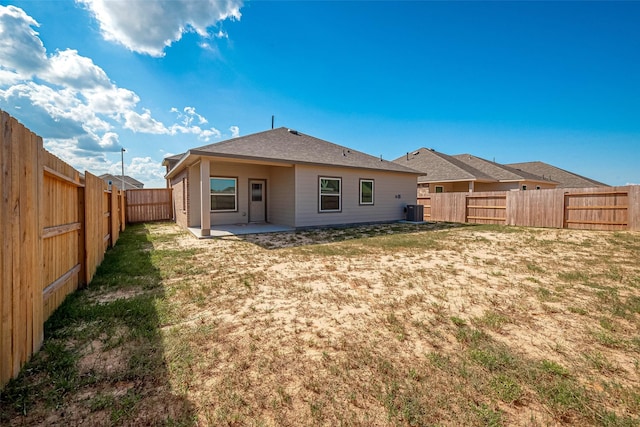 back of house featuring a patio, cooling unit, and a lawn