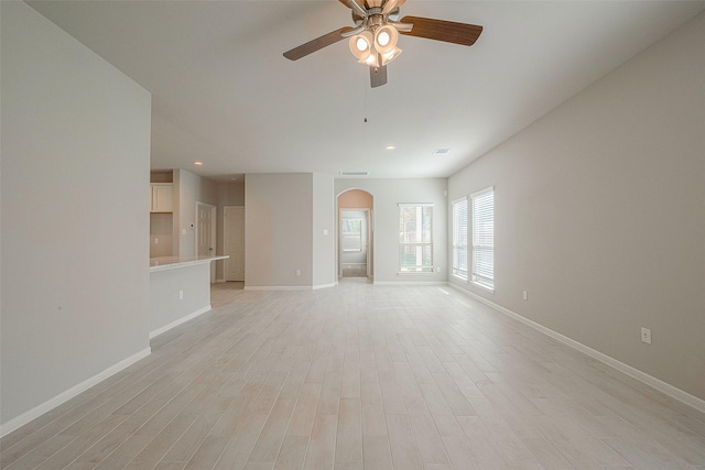 unfurnished living room featuring ceiling fan and light hardwood / wood-style flooring