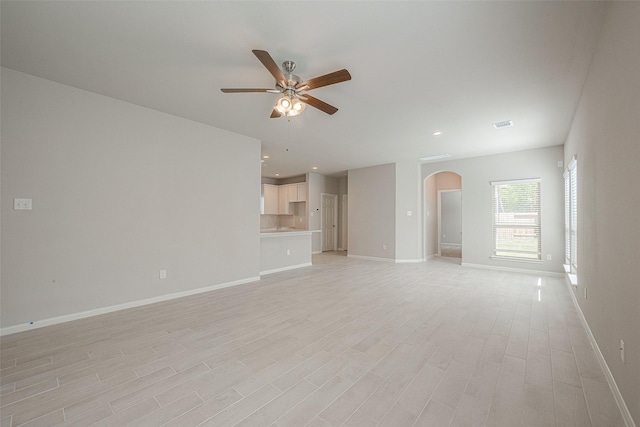 unfurnished living room with ceiling fan and light hardwood / wood-style floors