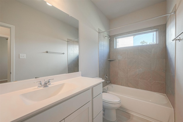 full bathroom featuring vanity, toilet, and tiled shower / bath