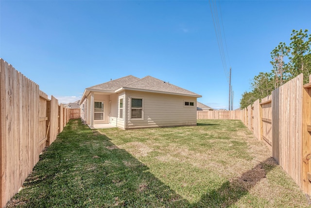 rear view of property featuring a yard