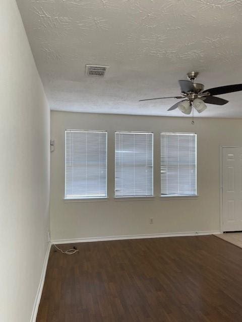 empty room featuring ceiling fan, a textured ceiling, and hardwood / wood-style flooring