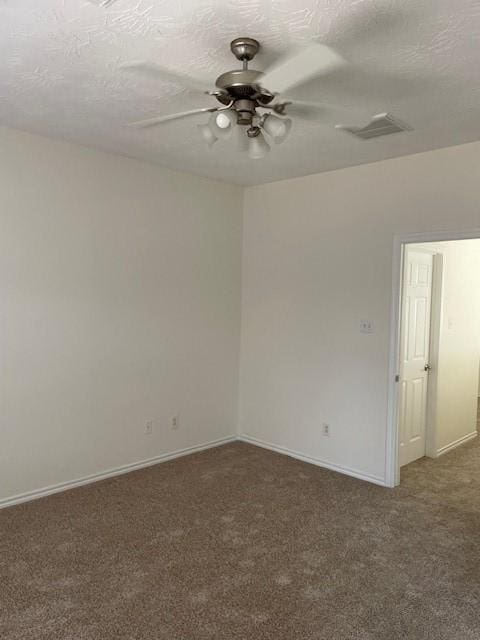 carpeted empty room with ceiling fan and a textured ceiling