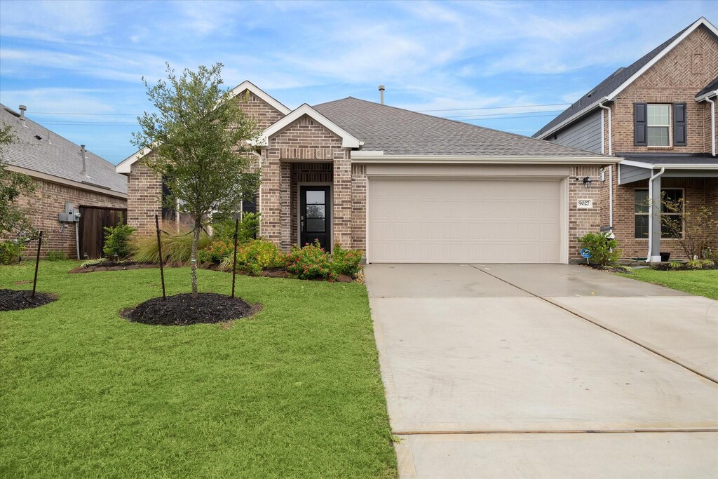 view of front of property with a garage and a front yard