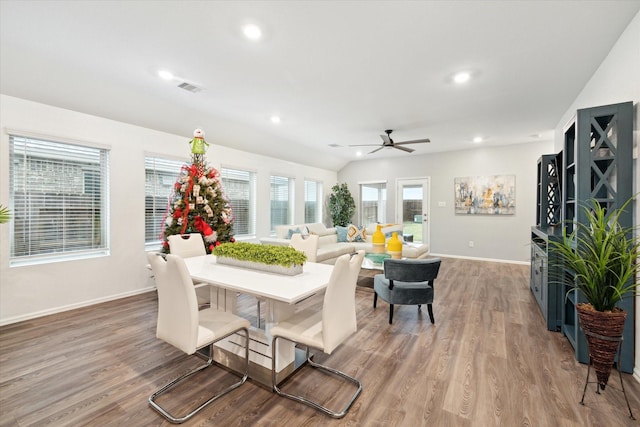 living room featuring light hardwood / wood-style floors, vaulted ceiling, and ceiling fan