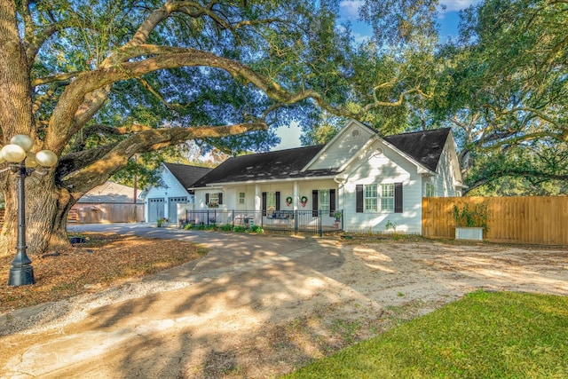 single story home featuring a porch and a garage