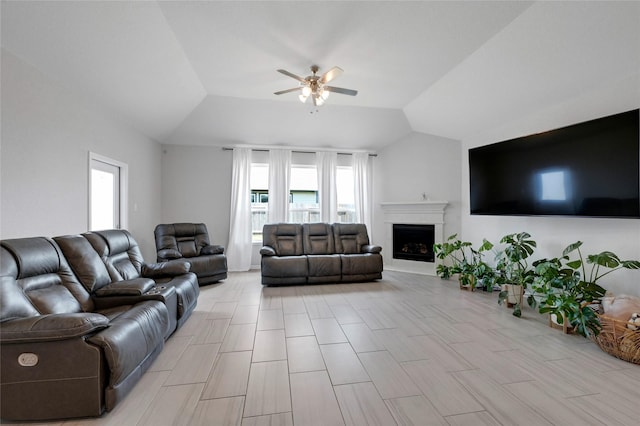 living room featuring vaulted ceiling and ceiling fan