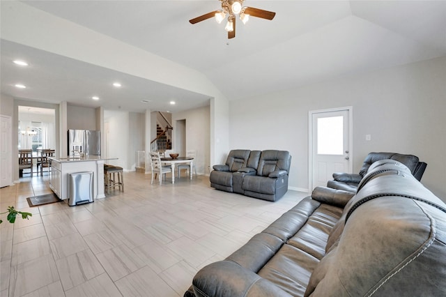 living room featuring plenty of natural light, ceiling fan, and vaulted ceiling