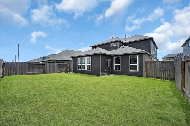 rear view of house with a yard