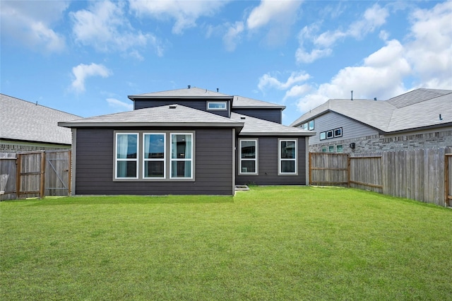 rear view of house with a yard