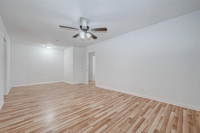 unfurnished room featuring ceiling fan, baseboards, visible vents, and light wood-style floors