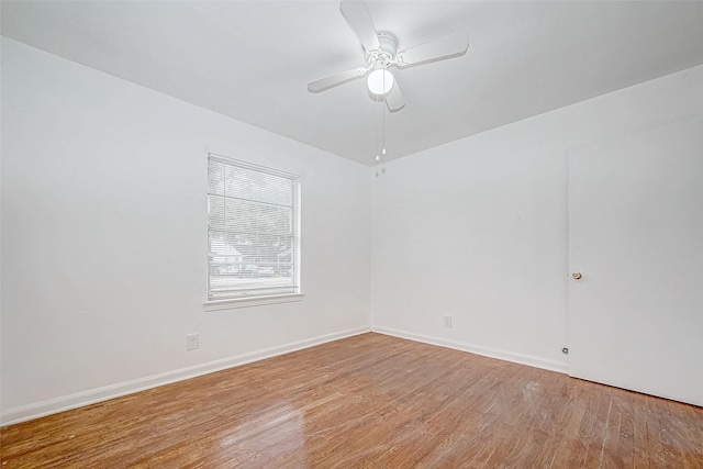 empty room with wood-type flooring and ceiling fan