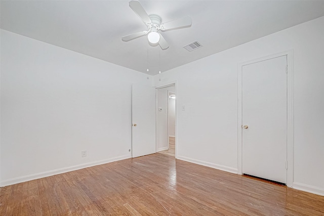 empty room featuring ceiling fan and light hardwood / wood-style floors