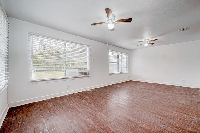 unfurnished room featuring ceiling fan, dark hardwood / wood-style flooring, and a textured ceiling