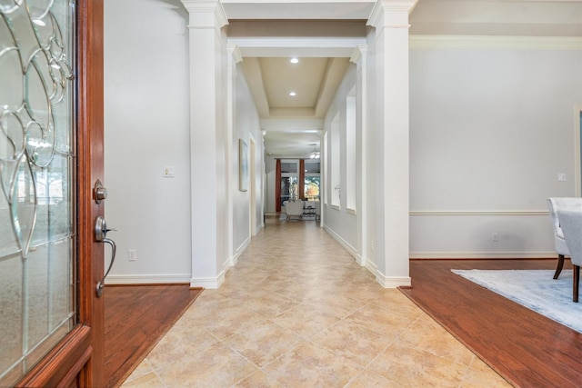 entryway with ornate columns and ornamental molding