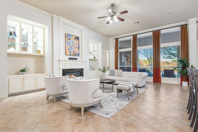 tiled living room with built in features, ceiling fan, and crown molding