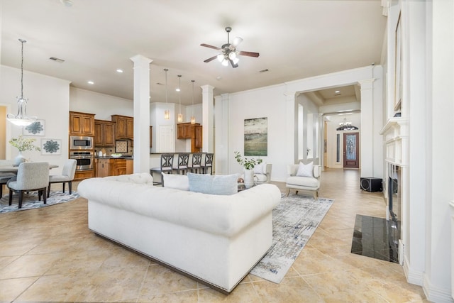 living room featuring ceiling fan and crown molding