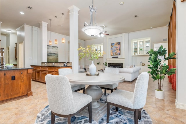 dining area with ceiling fan and crown molding