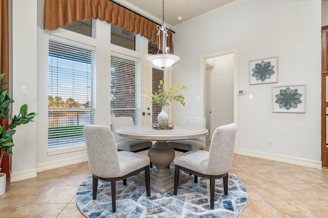 tiled dining area featuring ornamental molding