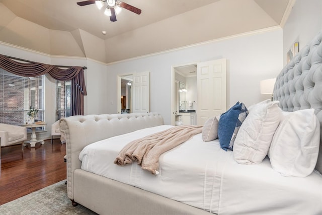 bedroom with a raised ceiling, ceiling fan, crown molding, hardwood / wood-style flooring, and connected bathroom