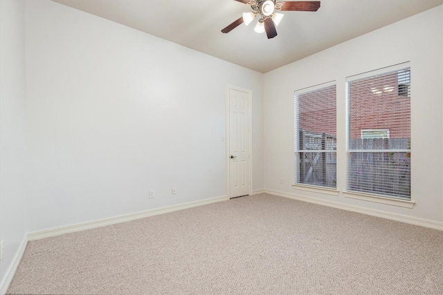 carpeted spare room with ceiling fan