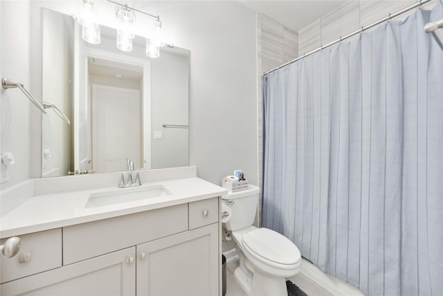 bathroom with vanity, curtained shower, and toilet