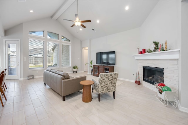 living room with ceiling fan, a fireplace, beamed ceiling, and high vaulted ceiling