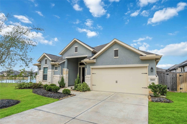 craftsman inspired home with a garage and a front lawn