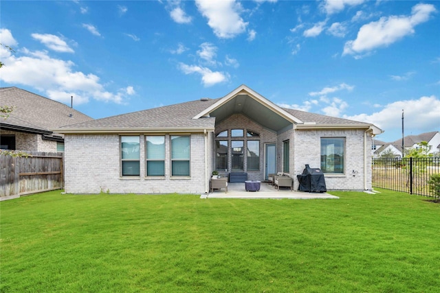 rear view of house with a yard and a patio