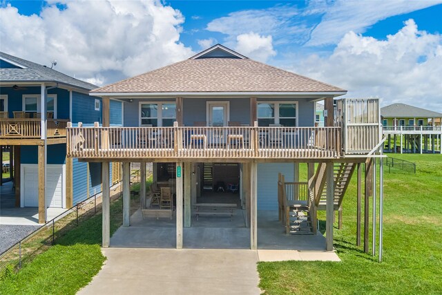 view of front of home with a patio area, a front lawn, covered porch, and a carport