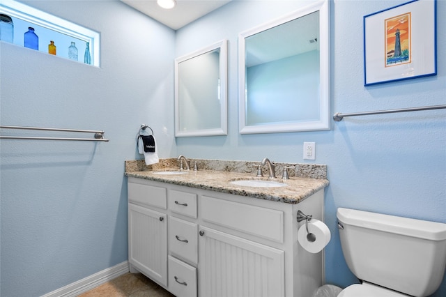 bathroom featuring tile patterned floors, vanity, and toilet