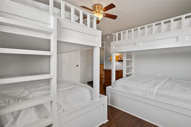 bedroom with ceiling fan and dark wood-type flooring