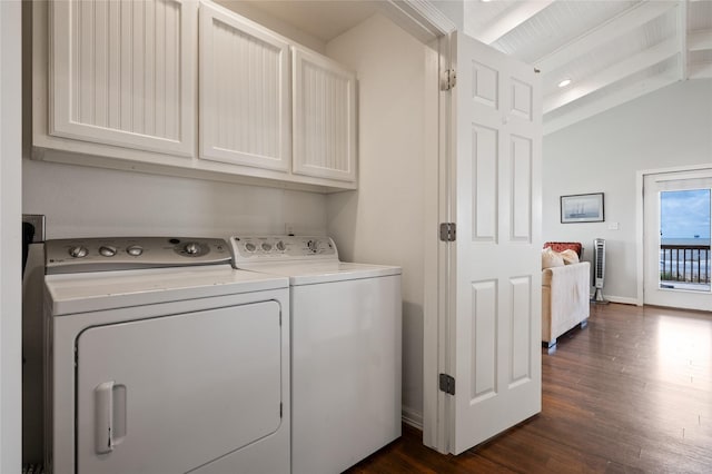 laundry room with washer and dryer, cabinets, and dark wood-type flooring