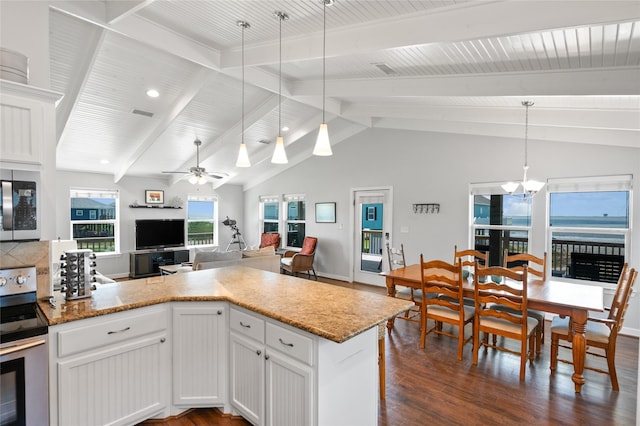 kitchen featuring ceiling fan with notable chandelier, stainless steel appliances, dark wood-type flooring, pendant lighting, and white cabinetry