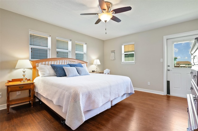 bedroom with multiple windows, ceiling fan, and dark wood-type flooring