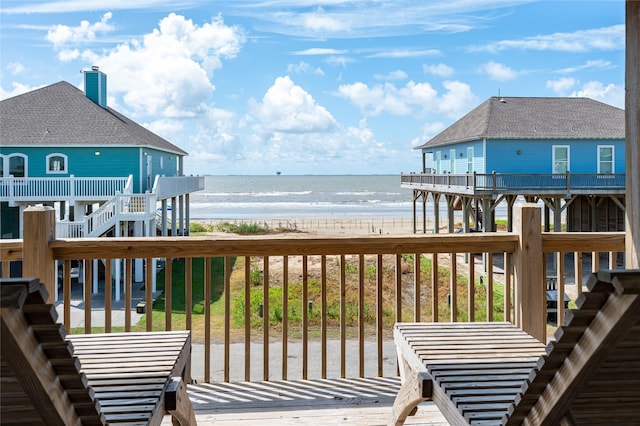 deck featuring a water view and a view of the beach