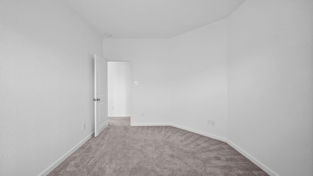 unfurnished room featuring light carpet