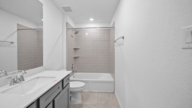 full bathroom featuring tile patterned flooring, vanity, tiled shower / bath combo, and toilet