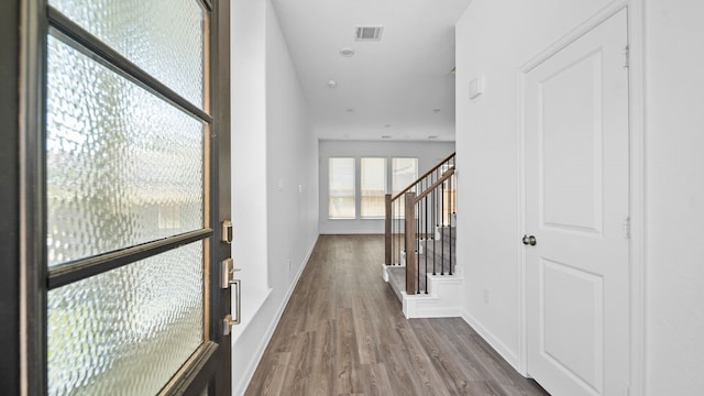 hall with hardwood / wood-style floors