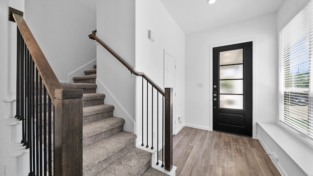 foyer entrance with light hardwood / wood-style floors