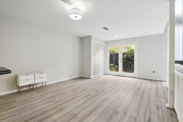 interior space with light wood-type flooring and french doors