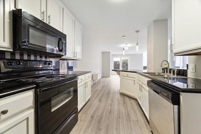 kitchen featuring sink, black appliances, pendant lighting, light hardwood / wood-style flooring, and white cabinets